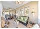 Relaxing sunroom featuring wicker furniture and ceiling fans at 16182 Sw 14Th Ave Rd, Ocala, FL 34473