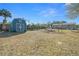 Spacious backyard with shed, boat, and fire pit, offering plenty of storage at 17175 Ne Jacksonville Rd, Citra, FL 32113