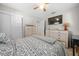 Main bedroom with a dresser, ceiling fan, and large TV at 17175 Ne Jacksonville Rd, Citra, FL 32113