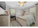 Cozy bedroom with a wooden bed frame and window curtains at 17175 Ne Jacksonville Rd, Citra, FL 32113