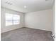 Bright bedroom with grey carpet and large window at 27 Hickory Course Ln, Ocala, FL 34472