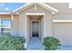 Front entry with a dark brown door and sidelights at 27 Hickory Course Ln, Ocala, FL 34472