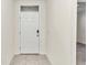 Interior entryway with a white door and neutral walls at 27 Hickory Course Ln, Ocala, FL 34472