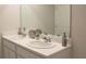 Double vanity bathroom with modern fixtures and ample counter space at 3290 Bertram Rd, Wildwood, FL 34785