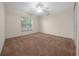 Simple bedroom with carpet, window, and ceiling fan at 37 Willow Run, Ocala, FL 34472