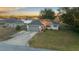 House exterior featuring a gray garage door and red front door at 37 Willow Run, Ocala, FL 34472