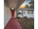 Inviting front entrance with red door and walkway at 37 Willow Run, Ocala, FL 34472