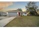 Single-story home with gray garage door and brick accents at 37 Willow Run, Ocala, FL 34472