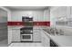 Modern kitchen with stainless steel appliances and red accents at 37 Willow Run, Ocala, FL 34472