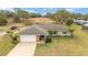 Single-story home with large backyard and driveway at 5041 County Road 114, Wildwood, FL 34785