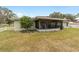 Spacious backyard with screened patio and grassy area at 5041 County Road 114, Wildwood, FL 34785