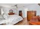 Bright bedroom featuring a king-size bed and wood dresser at 5041 County Road 114, Wildwood, FL 34785