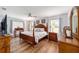 Spacious main bedroom with hardwood floors and large windows at 5041 County Road 114, Wildwood, FL 34785