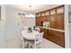 Charming dining area with white table and built-in cabinetry at 5041 County Road 114, Wildwood, FL 34785