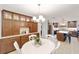 Bright dining room with white table and built-in wooden cabinets at 5041 County Road 114, Wildwood, FL 34785