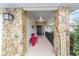 Inviting entryway with stone columns and a charming bench at 5041 County Road 114, Wildwood, FL 34785