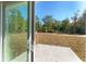 Sliding glass door opens to a patio and grassy backyard at 53 Guava Pl, Ocklawaha, FL 32179