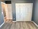 Bedroom with double door closet and wood-look floors at 6082 Sw 104Th St, Ocala, FL 34476