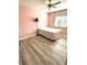 Cozy bedroom with light pink walls, wood-look floors, and ceiling fan at 6082 Sw 104Th St, Ocala, FL 34476