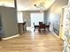 Bright dining room featuring a wood-look floor and stylish light fixture at 6082 Sw 104Th St, Ocala, FL 34476