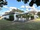 Home's exterior showcasing a well-maintained lawn and screened porch at 6082 Sw 104Th St, Ocala, FL 34476