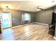 Bright living room with gray walls, wood-look floors, and a yellow door at 6082 Sw 104Th St, Ocala, FL 34476