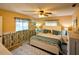 Bright bedroom with a king-size bed, ceiling fan and ample natural light at 6180 Sw 110Th St, Ocala, FL 34476