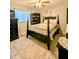 Cozy bedroom with a queen-size bed, ceiling fan, and built-in shelving at 6180 Sw 110Th St, Ocala, FL 34476