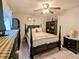 Charming bedroom with a queen-size bed, ceiling fan, and built-in shelving at 6180 Sw 110Th St, Ocala, FL 34476