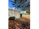 Single car garage with white door and mature landscaping at 6180 Sw 110Th St, Ocala, FL 34476