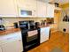 Kitchen with granite countertops, white cabinets, and black appliances at 6180 Sw 110Th St, Ocala, FL 34476