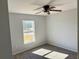 Well-lit bedroom with ceiling fan and carpeted floor at 6189 Sw 134Th St, Ocala, FL 34473