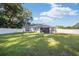 Large backyard with screened porch and white vinyl fence at 66 Teak Loop, Ocala, FL 34472