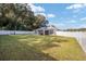 Backyard view showing home's exterior and large grassy area at 66 Teak Loop, Ocala, FL 34472