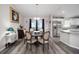 Bright dining room with round wooden table and six chairs, view of kitchen at 66 Teak Loop, Ocala, FL 34472