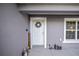 White front door with wreath and garden gnomes at 66 Teak Loop, Ocala, FL 34472