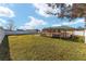 Large backyard with grassy area and wooden deck at 73 Bahia Trace Crse, Ocala, FL 34472