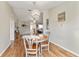 Bright dining room features a charming table and chairs, hardwood floors, and a chandelier at 73 Bahia Trace Crse, Ocala, FL 34472