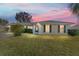 Tan house with green roof, nicely landscaped lawn at 73 Bahia Trace Crse, Ocala, FL 34472