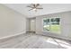 Bright living room featuring wood-look floors and a large window at 753 Nw 63Rd Pl, Ocala, FL 34475