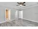 Main bedroom with wood-look floors and ceiling fan at 753 Nw 63Rd Pl, Ocala, FL 34475