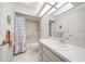 Well-lit bathroom features a shower-tub combo and a large mirror at 8188 Sw 108Th Loop, Ocala, FL 34481