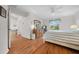 Bedroom with wood floors, a ceiling fan, and a view to the outside at 8188 Sw 108Th Loop, Ocala, FL 34481