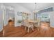 Bright dining room with chandelier lighting, hardwood flooring, and seamless access to living area at 8188 Sw 108Th Loop, Ocala, FL 34481