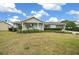 Single-story house with a covered porch, neatly landscaped lawn, and a driveway at 8188 Sw 108Th Loop, Ocala, FL 34481