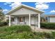 Inviting front porch with white columns, manicured shrubs and a well maintained walkway at 8188 Sw 108Th Loop, Ocala, FL 34481