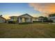 Charming single-story home with a well-manicured front yard and covered porch at sunset at 8188 Sw 108Th Loop, Ocala, FL 34481