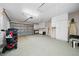 Bright garage with overhead storage and an automatic garage door at 8188 Sw 108Th Loop, Ocala, FL 34481