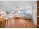 Cozy living room featuring hard wood floors, a ceiling fan, and natural light from multiple windows at 8188 Sw 108Th Loop, Ocala, FL 34481