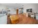 Living room features hardwood floors, a sofa, and a view into the kitchen at 8188 Sw 108Th Loop, Ocala, FL 34481